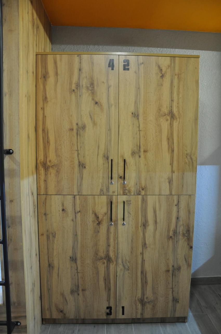 Full House Capsule Hostel Rivne Exterior photo A wooden armoire